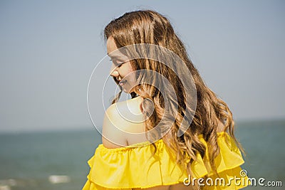 Portrait Asian girl long hair, bikini two-tone white and yellow, standing post happy posture by the sea, in Thailand South Asia, Stock Photo