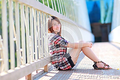 Portrait of the asian girl 20 years old posing outdoors wear plaid shirt Stock Photo