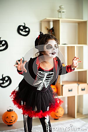 Portrait Asian little girl in Halloween costume acting scary and Stock Photo