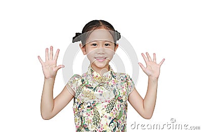Portrait of Asian little girl wearing cheongsam with smiling and shows two palms, give five isolated over white background Stock Photo
