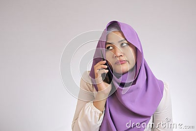 Muslim Woman Looks Annoyed Waiting on the Phone Stock Photo