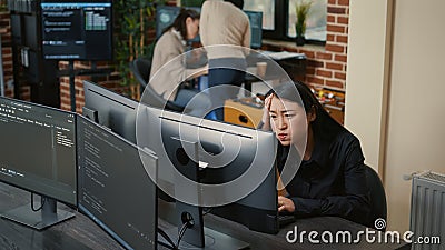 Portrait of asian programer focused on writing code encounters unexpected compiling error Stock Photo