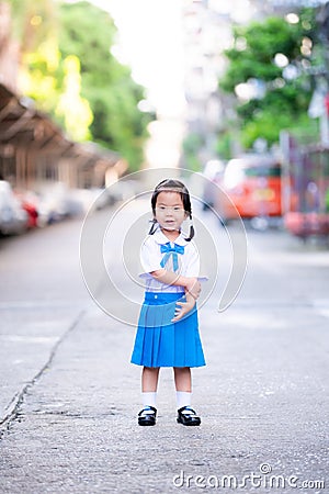 Portrait of Asian pupils girl wearing blue and white school uniform. Stock Photo