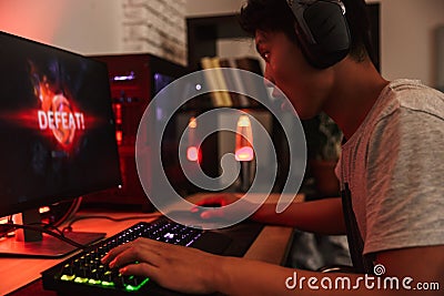 Portrait of asian teenage gamer boy losing while playing video g Stock Photo