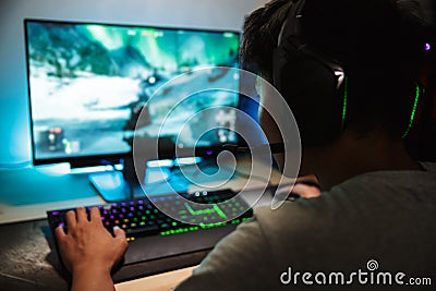 Portrait of asian teenage gamer boy playing video games online o Stock Photo