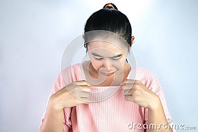 Portrait of Asian young woman looked at her breasts with unsatisfied and sad, wants to make plastic surgery on breast Stock Photo