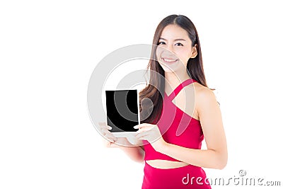 Portrait of asian young woman with red dress standing showing blank screen tablet. Stock Photo