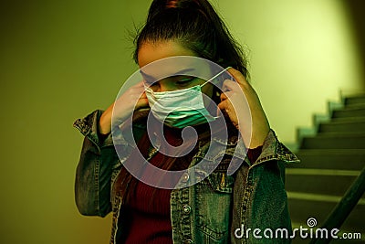 Portrait of an Asian young woman. stairwell of the hospital. the girl wears a mask to avoid getting infected with the virus Stock Photo