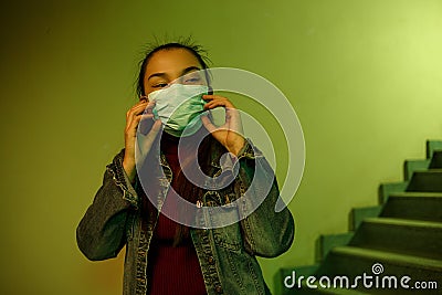 Portrait of an Asian young woman. stairwell of the hospital. the girl wears a mask to avoid getting infected with the virus Stock Photo