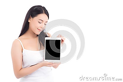 Portrait of asian young woman standing showing blank screen tablet isolated on white background Stock Photo