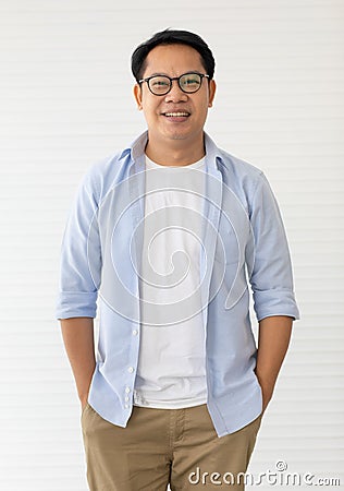 Portrait of Asin man wearing eyeglasses standing with self-confident and friendly-looking Stock Photo