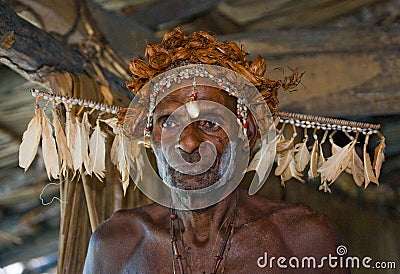 The Portrait Asmat warrior with a traditional painting and coloring on a face. Editorial Stock Photo