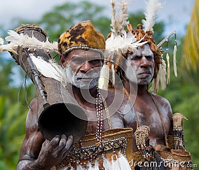 Portrait Asmat warrior with a tribal ritual drum. Editorial Stock Photo