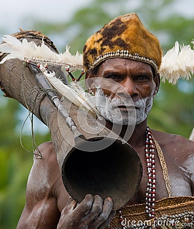 Portrait Asmat warrior with a tribal ritual drum. Editorial Stock Photo