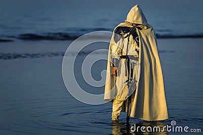 Portrait of assassin in white costume. Stock Photo