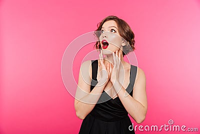 Portrait of an astonished girl dressed in black dress Stock Photo