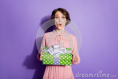 Portrait of astonished girl hold gift box dont wait present from her boyfriend on 8-march stare stupor wear polka-dot Stock Photo