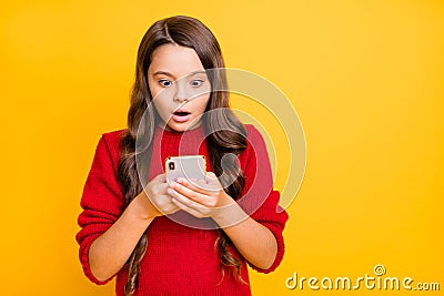 Portrait of astonished negative child use her smartphone stare stupor get notification dislike in her blog wear stylish Stock Photo