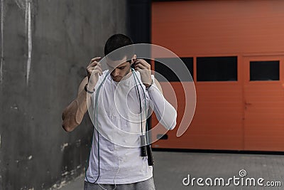 Portrait athletic man getting ready to rope jumping while firing Stock Photo