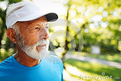 Portrait of athletic mature man after run. Handsome senior man resting after jog at the park Stock Photo