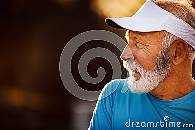 Portrait of athletic mature man after run. Handsome senior man resting after jog at the park Stock Photo