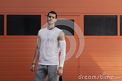 Portrait athletic, muscular man preparing for warming up with ju Stock Photo