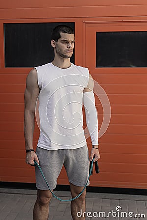 Portrait athletic, muscular man preparing for warming up with ju Stock Photo