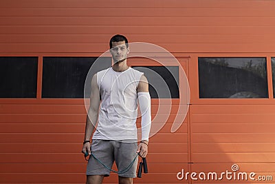 Portrait athletic, muscular man preparing for warming up with ju Stock Photo