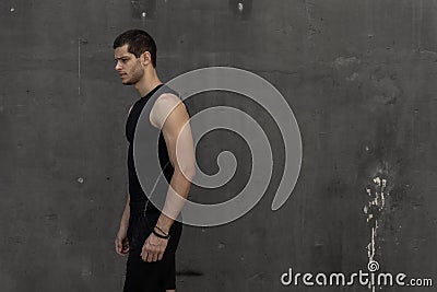 Sport model man posing gray wall background Stock Photo