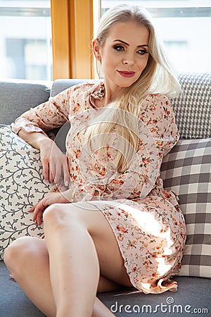 Portrait of attractive blonde woman in flowers dress Stock Photo