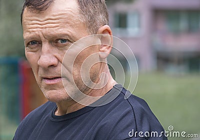 Portrait of an attractive brave middle-aged man wearing a black t-shirt Stock Photo
