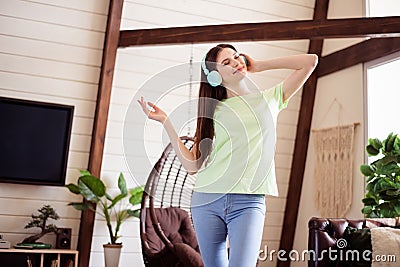 Portrait of attractive cheerful dreamy girl listening soul jazz spending free spare time at house flat indoors Stock Photo