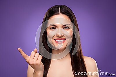 Portrait of attractive cheerful long-haired girl using contact lenses isolated over bright violet purple color Stock Photo