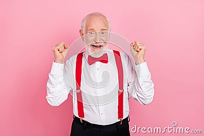 Portrait of attractive cheerful lucky gray-haired guy having fun rejoicing festal occasion isolated over pink pastel Stock Photo