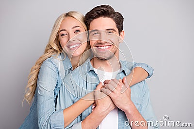 Portrait of attractive cheerful tender couple life partners hugging bonding isolated over gray pastel color background Stock Photo