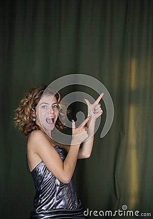 Portrait of attractive coquettish funny girl 18 years , hand gesture gives good recommendation Stock Photo