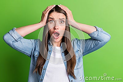 Portrait of attractive desperate girl grief bad news reaction panic isolated over bright green color background Stock Photo