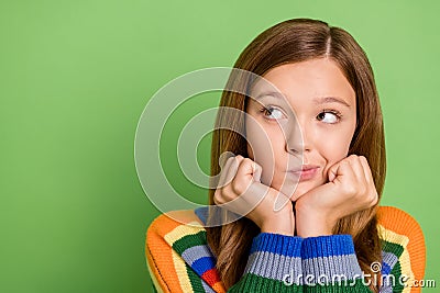 Portrait of attractive doubtful hesitant bewildered red-haired girl thinking copy space isolated over bright green color Stock Photo
