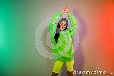 Portrait of attractive dreamy cheerful girl dancing rest relax chill out night isolated over multicolor vivid neon light Stock Photo