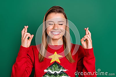 Portrait of attractive dreamy cheerful girl praying want gift present crossed fingers isolated over green color Stock Photo