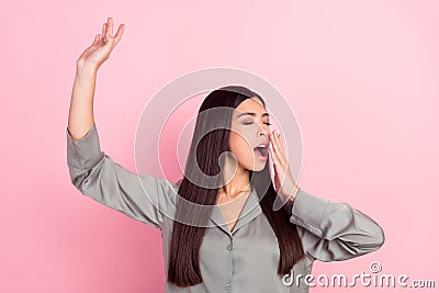 Portrait of attractive dreamy girl awakening stretching yawning over pink pastel color background Stock Photo