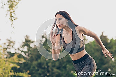 Portrait of attractive focused purposeful girl doing workout running early morning day shaping pilates outdoor Stock Photo