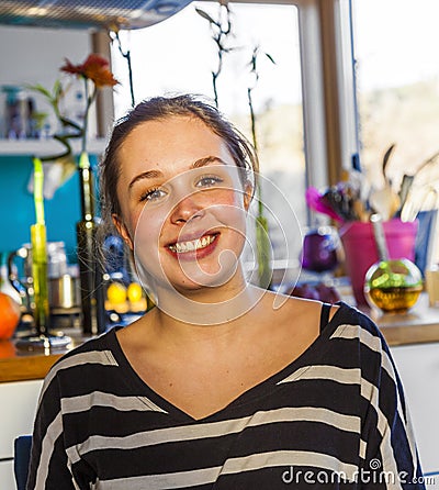 Portrait of attractive girl smiling at home Stock Photo