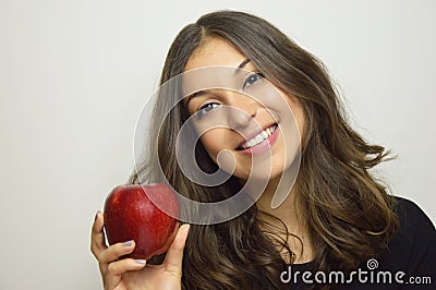 Portrait of attractive girl smiling with red apple in her hand healthy fruit Stock Photo