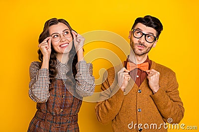 Portrait of attractive minded cheerful smart couple creating solution isolated over bright yellow color background Stock Photo