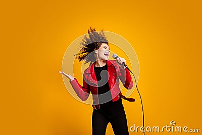 Portrait of attractive popular wavy-haired girl solist vocalist singing hit isolated on bright yellow color background Stock Photo