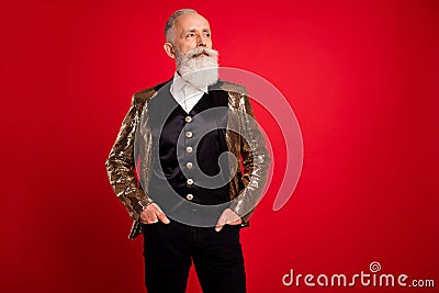 Portrait of attractive proud chic classy grey-haired man holding hands in pockets isolated over bright red color Stock Photo