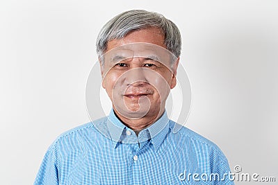 Portrait of attractive senior asian man smiling and looking at camera in studio Stock Photo