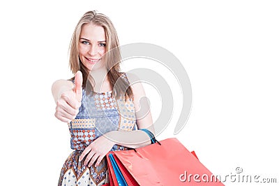 Portrait of attractive smiling girl with shopping bags showing t Stock Photo