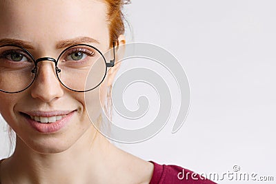 Portrait of attractive young redhead woman smiling with glasses Stock Photo